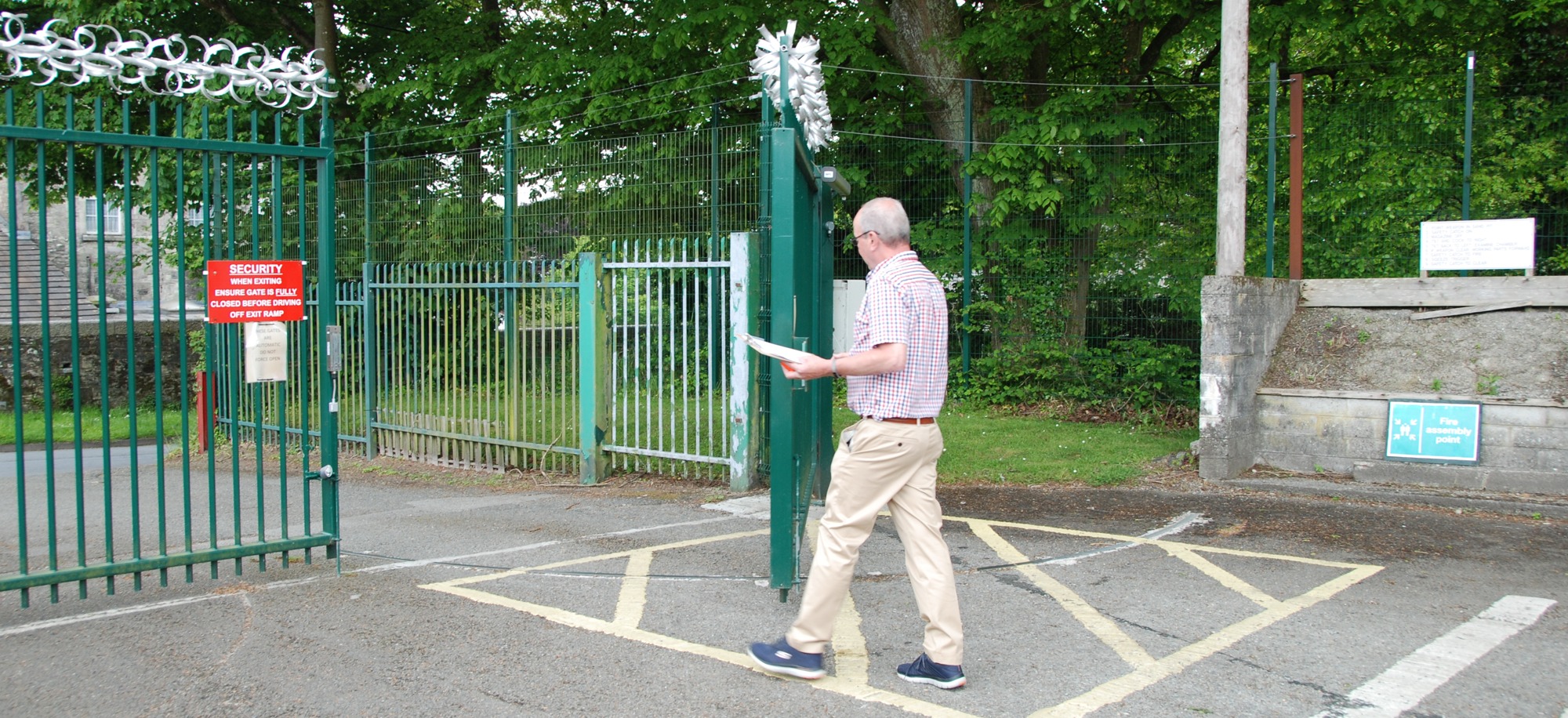 Richard Jackson checking large, green automated gate