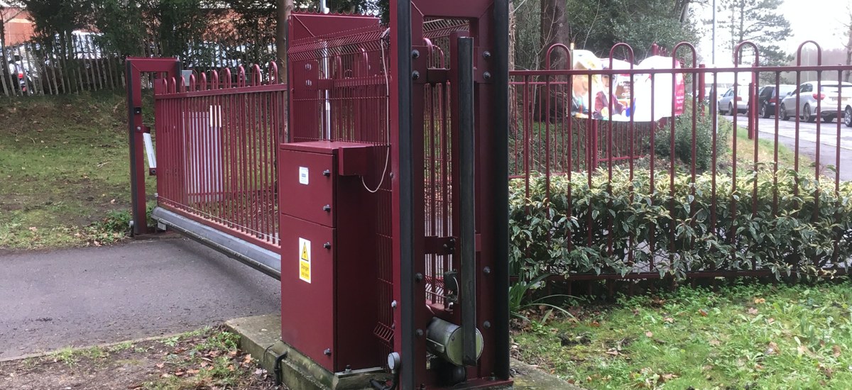maroon automated gate outside school